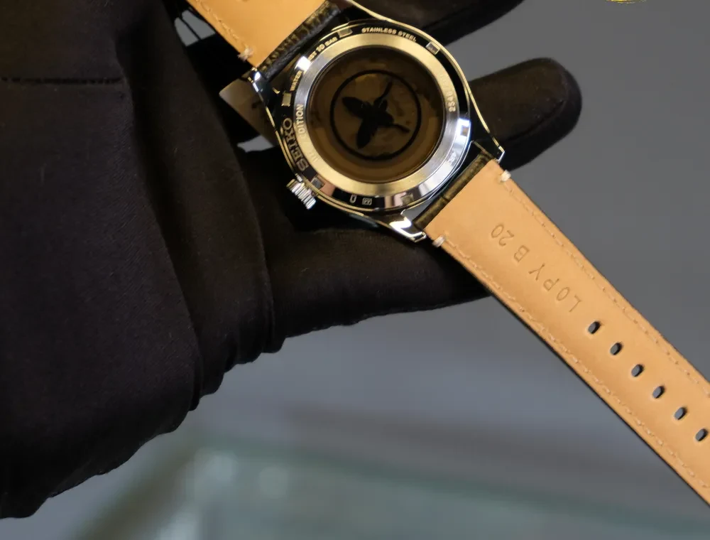 Case back of Seiko SRPL31 with brown tint and feather logo